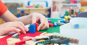 Child building with LEGO bricks.